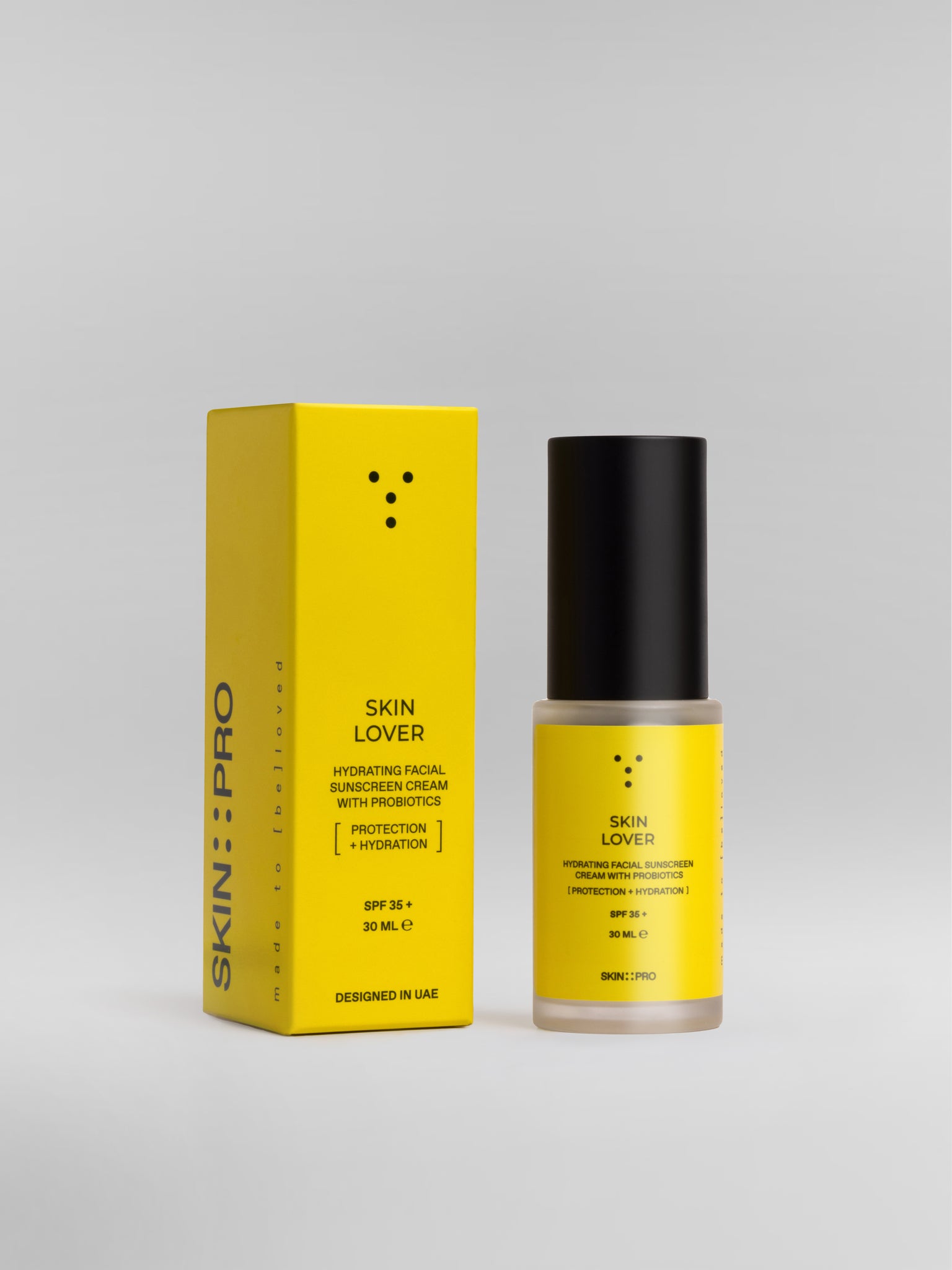 A bottle of SkinLover hydrating facial sunscreen cream with a yellow label, next to its packaging box.