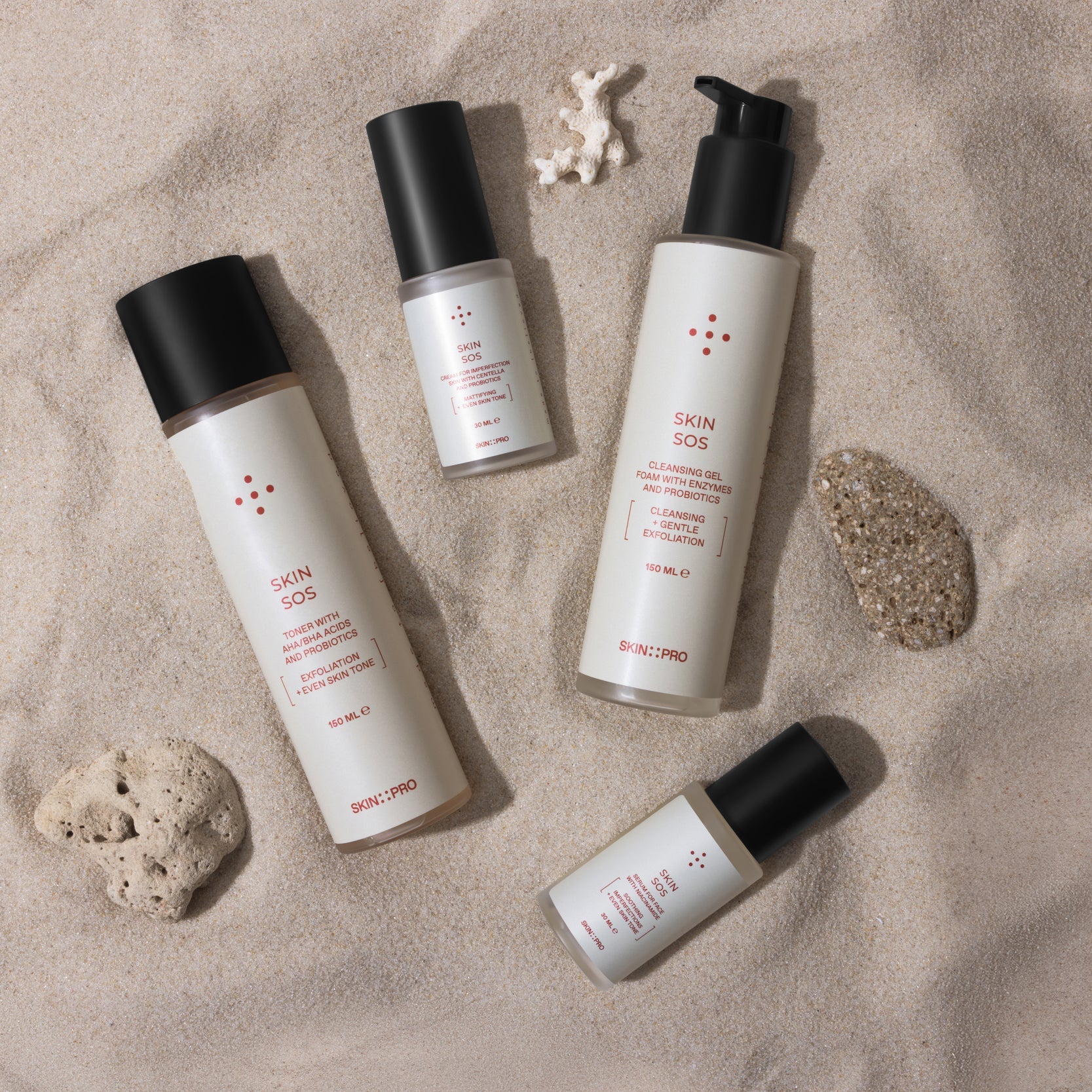 Set of skincare products on a sandy background
